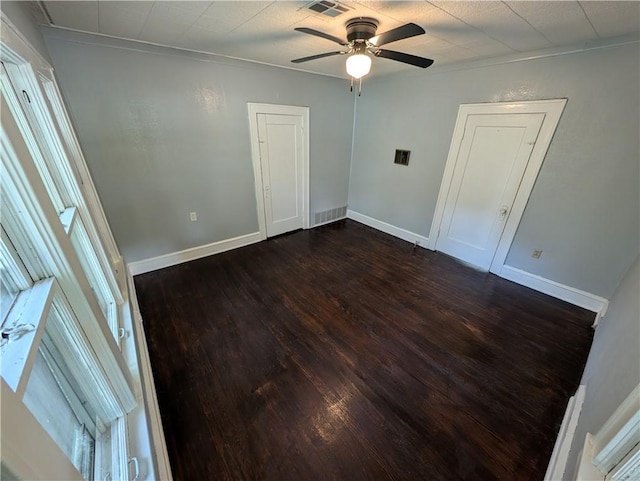 unfurnished bedroom featuring ceiling fan, crown molding, and dark hardwood / wood-style floors