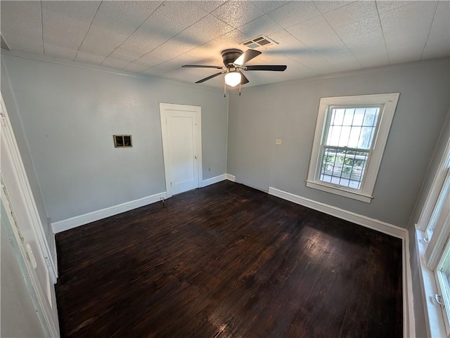 spare room featuring ceiling fan, dark hardwood / wood-style flooring, and crown molding