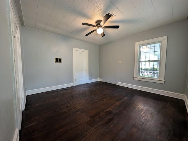 spare room with ceiling fan and dark wood-type flooring