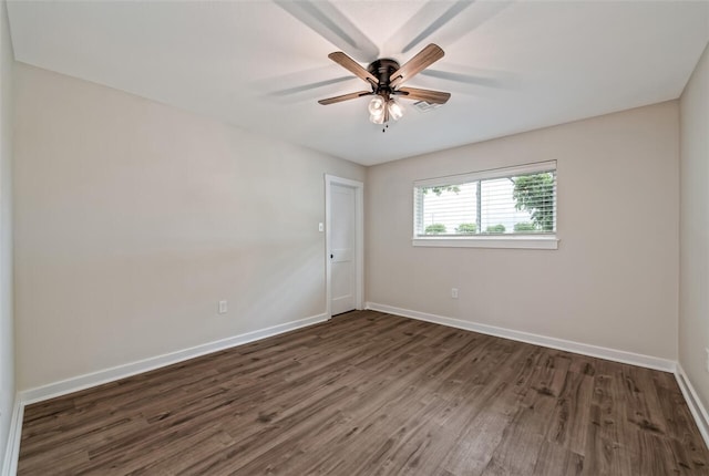 spare room with ceiling fan and dark wood-type flooring