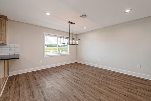 unfurnished dining area with dark hardwood / wood-style flooring