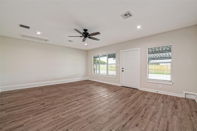 spare room featuring dark hardwood / wood-style floors and ceiling fan