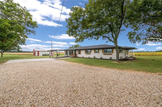 ranch-style house featuring a front lawn and a carport