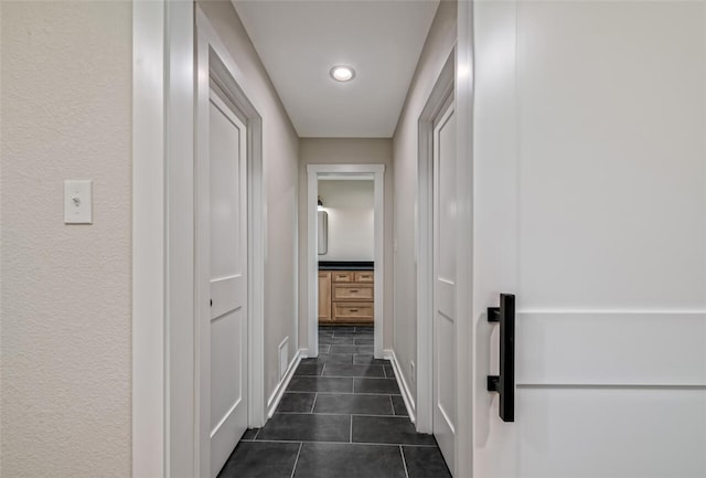 corridor with dark tile patterned flooring