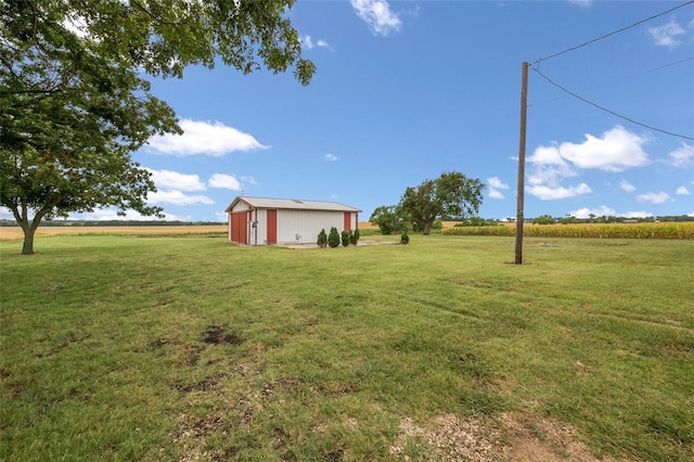 view of yard with a rural view and an outdoor structure