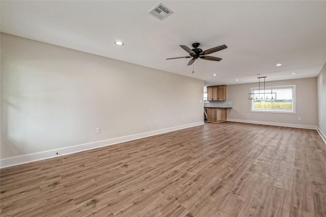 unfurnished living room featuring light hardwood / wood-style floors and ceiling fan