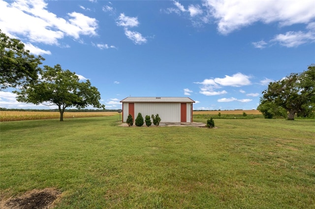 view of yard featuring a rural view and an outdoor structure