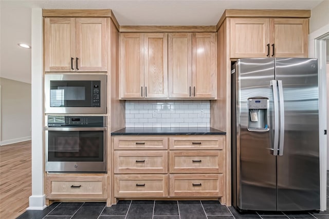 kitchen featuring tasteful backsplash, dark hardwood / wood-style flooring, light brown cabinetry, and stainless steel appliances