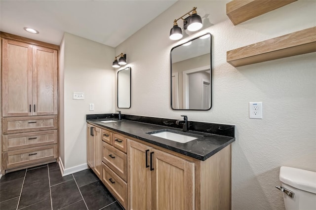 bathroom featuring tile patterned flooring, vanity, and toilet