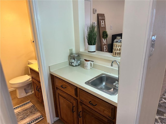 bathroom with vanity, toilet, and tile patterned flooring