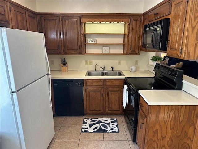 kitchen with sink, black appliances, and light tile patterned floors