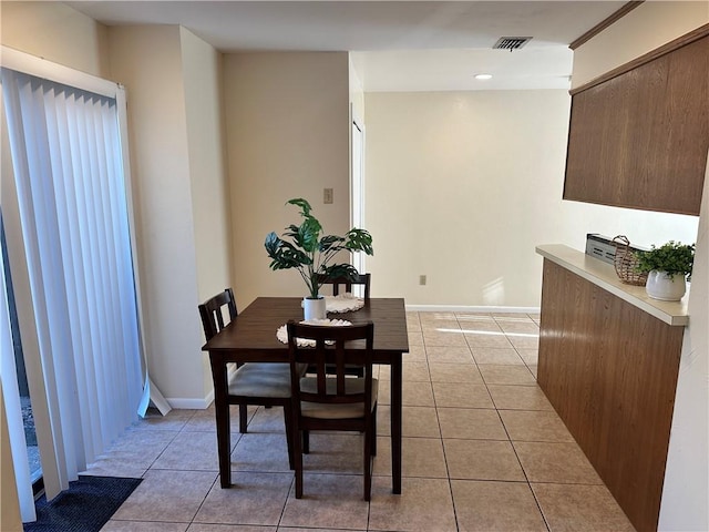 dining area with light tile patterned floors