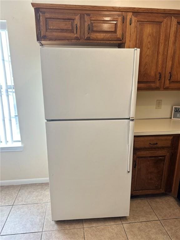 kitchen with white refrigerator and light tile patterned floors