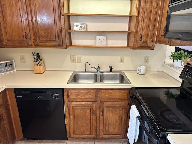 kitchen featuring sink, light tile patterned floors, and black appliances