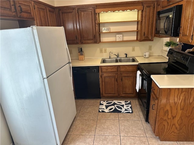 kitchen featuring sink, black appliances, and light tile patterned flooring