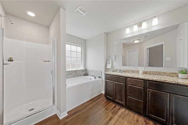 bathroom featuring vanity, independent shower and bath, and hardwood / wood-style flooring