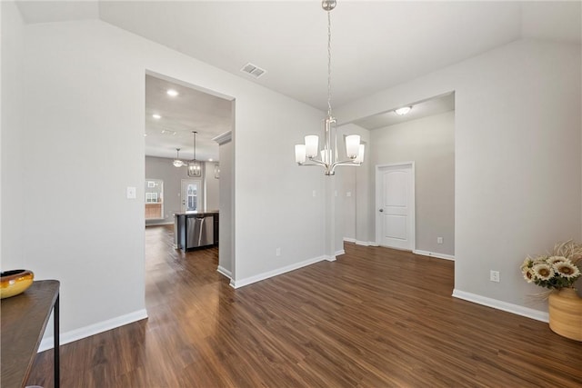 unfurnished dining area featuring an inviting chandelier and dark wood-type flooring