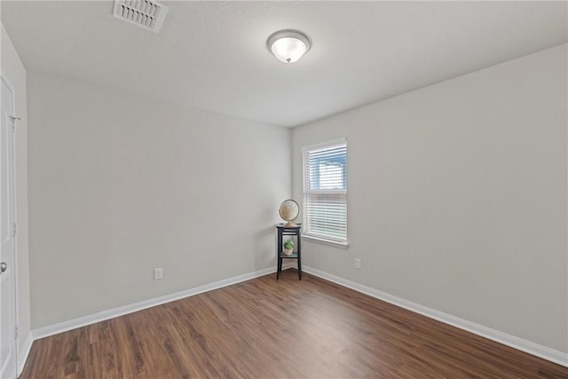 empty room with hardwood / wood-style floors