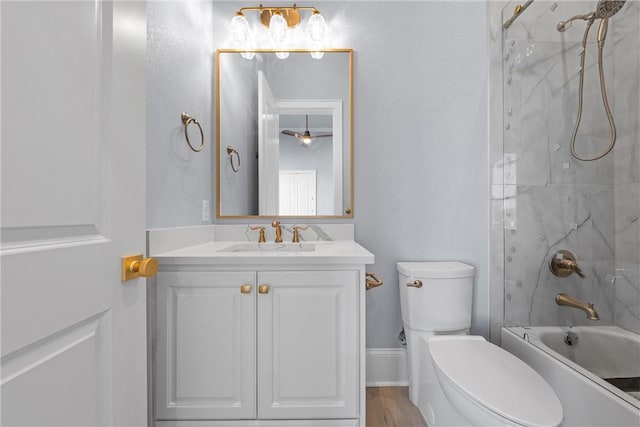 full bathroom with vanity, tiled shower / bath combo, ceiling fan, toilet, and wood-type flooring