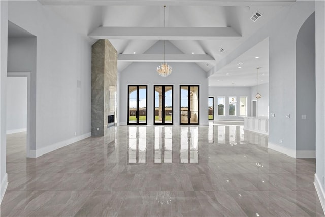 unfurnished living room featuring lofted ceiling with beams and an inviting chandelier