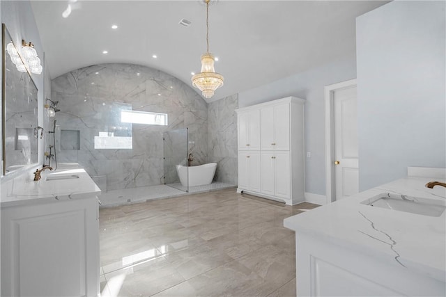 bathroom featuring a chandelier, vanity, and tiled shower