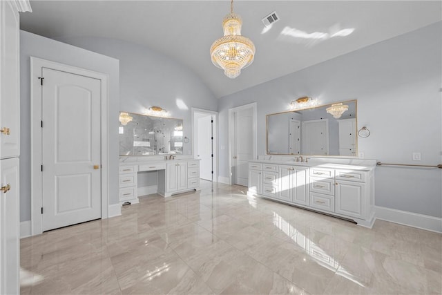 bathroom featuring vanity, lofted ceiling, and a notable chandelier