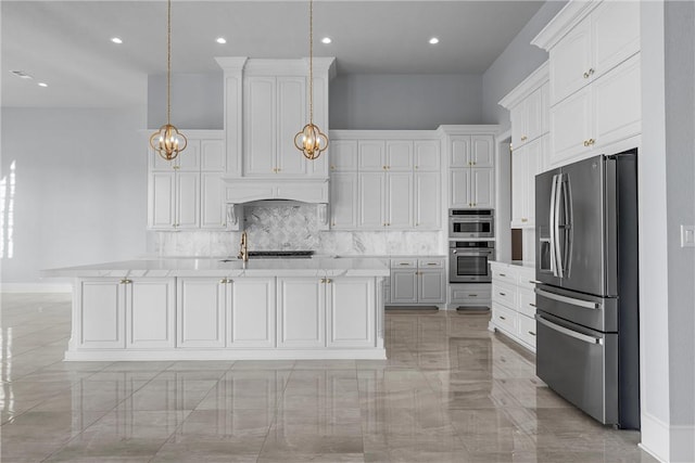 kitchen with hanging light fixtures, white cabinetry, a kitchen island with sink, and appliances with stainless steel finishes