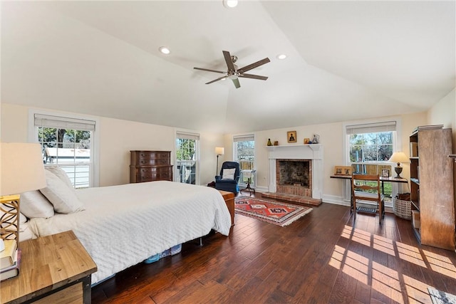 bedroom featuring multiple windows, vaulted ceiling, and hardwood / wood-style floors