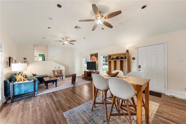 dining space featuring lofted ceiling, wood finished floors, visible vents, and baseboards