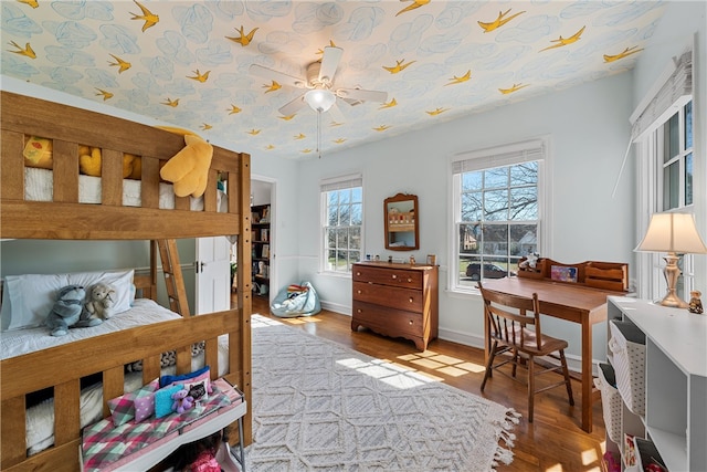 bedroom with baseboards and wood finished floors