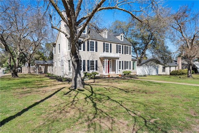 view of front of property with fence and a front lawn