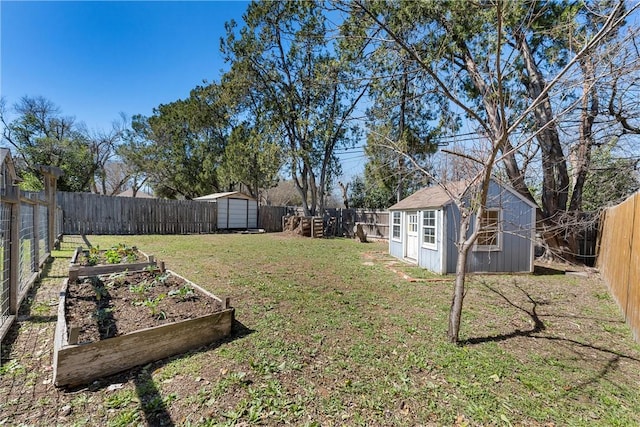 view of yard featuring a storage unit, an outdoor structure, a fenced backyard, and a garden