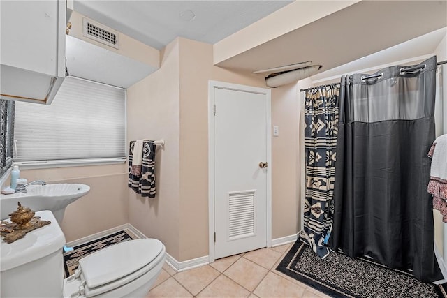 bathroom with tile patterned floors, sink, and toilet