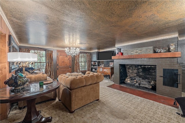 living room featuring a fireplace, ornamental molding, a textured ceiling, and a notable chandelier