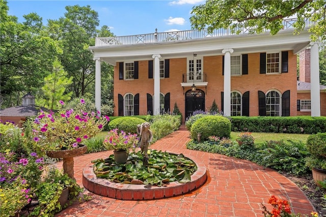 greek revival inspired property featuring a balcony