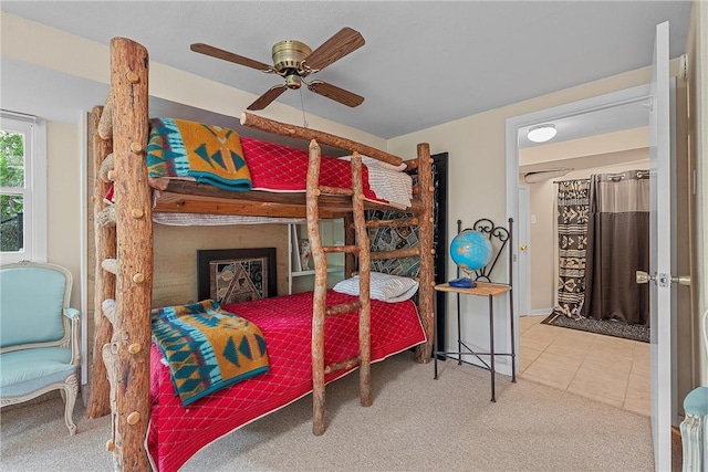 bedroom with ceiling fan and light carpet