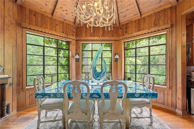 dining room with plenty of natural light, a notable chandelier, and wood ceiling