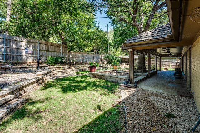 view of yard featuring ceiling fan and a patio area