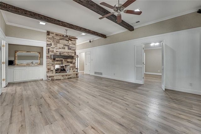 unfurnished living room featuring beamed ceiling, ceiling fan, light wood-type flooring, and a fireplace