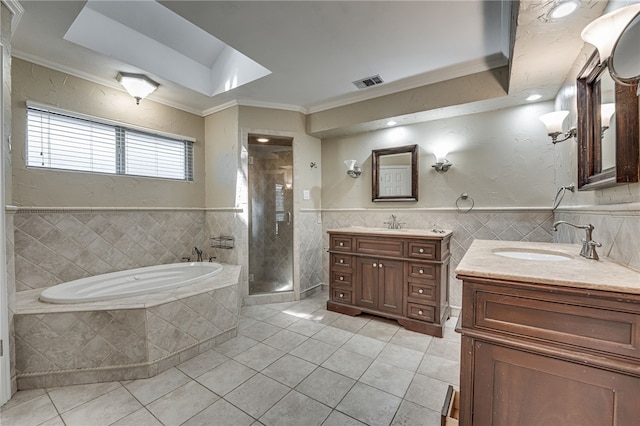 bathroom featuring tile patterned floors, vanity, separate shower and tub, crown molding, and tile walls