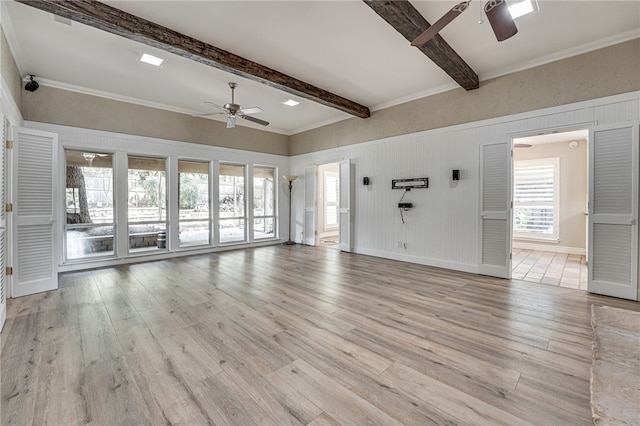 unfurnished living room with beam ceiling, light hardwood / wood-style floors, ceiling fan, and ornamental molding