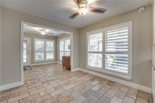 unfurnished room with ceiling fan