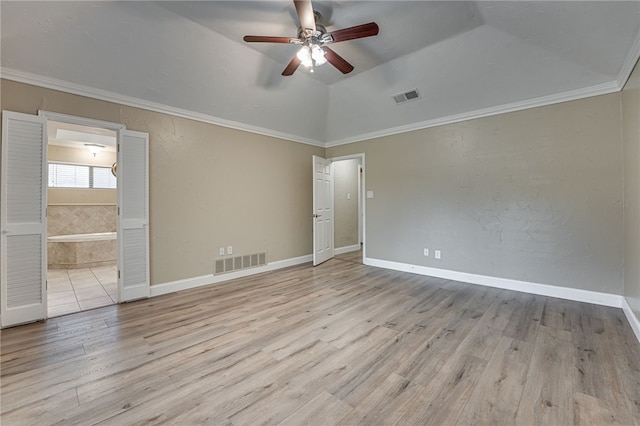 unfurnished room with ceiling fan, vaulted ceiling, crown molding, and light hardwood / wood-style flooring