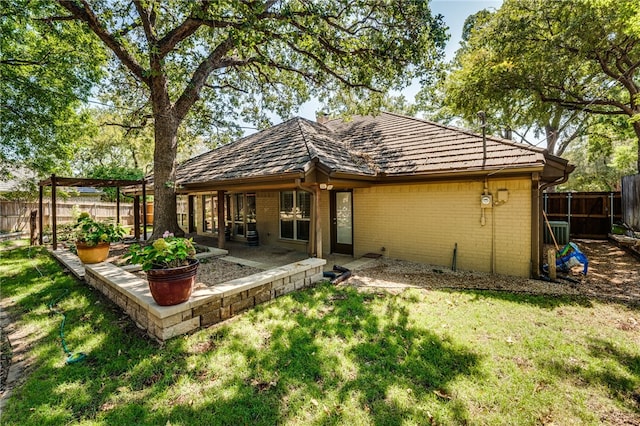 back of house featuring a yard and a patio