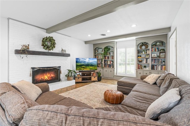 living room with beamed ceiling and a brick fireplace