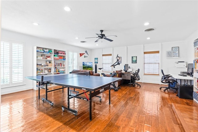 rec room with hardwood / wood-style flooring and ceiling fan