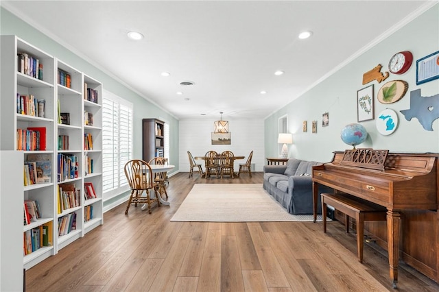 sitting room with light hardwood / wood-style floors and ornamental molding