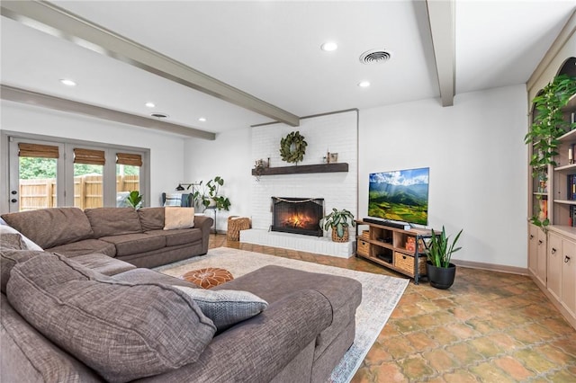 living room with beamed ceiling and a brick fireplace