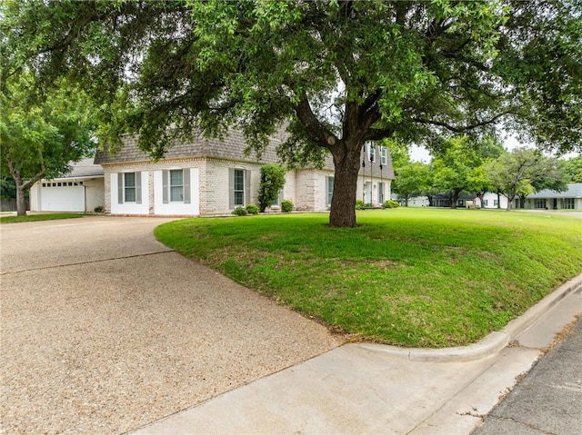 view of front of property featuring a garage and a front yard