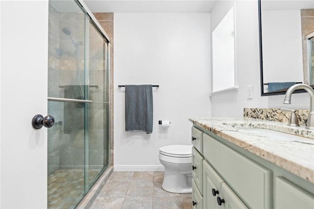 bathroom featuring vanity, toilet, and a shower with door